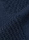 Close-up of the dark navy patchwork weave cotton labour jacket, showcasing the fabric's texture and color in a studio setting.