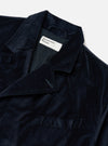 Close-up of the Navy Velveteen Manor Jacket on a white background. The jacket is a rich navy color and has a soft, velvety texture. Features a classic collar and button closure.