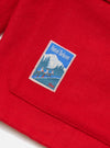 Close-up of the Embroidered Red Mowbray Military Fatigue Jacket showing the red fabric and embroidered patch detail. 