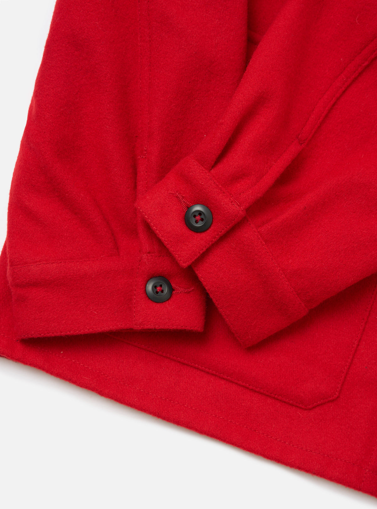 Close-up of the red Embroidered Mowbray Military Fatigue Jacket showing the sleeve and pocket detail. The jacket is on a white surface.