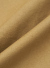 Close-up of the twill fabric of the Khaki Works Twill Rose Bowl Jacket. The material is a light brown color and has a subtle texture. The fabric is draped to show its quality.