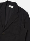 Close-up of the Black Organic Canvas Two Button Jacket on a white background. The jacket is made of black canvas and has a two-button closure.