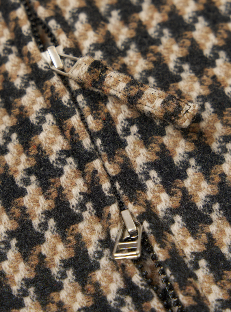 Close-up of the Sand Cortina Tweed Windcheater, showcasing the tweed material and zipper. The tweed is a mix of sand, brown, and black. 
