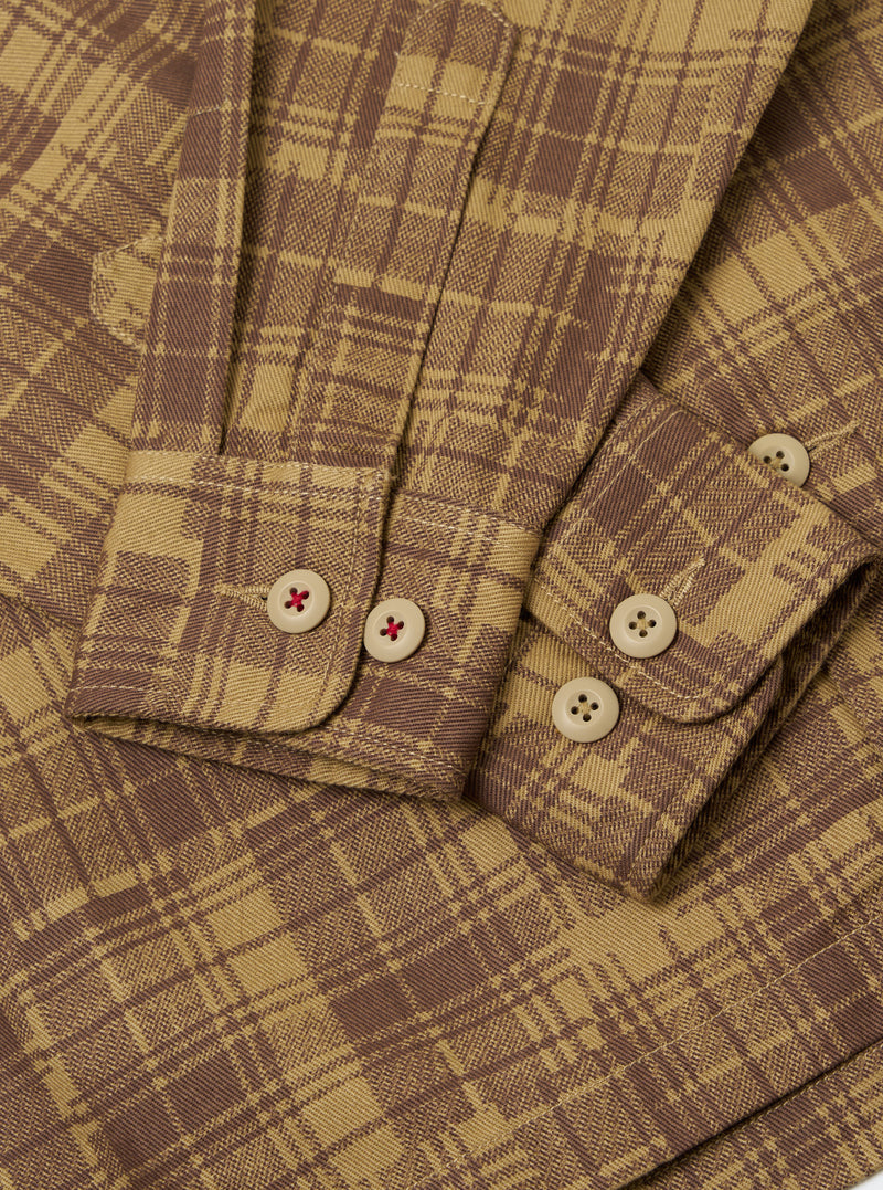Close-up of the Khaki Patch Check Twill Fatigue Shirt. The shirt features a brown and khaki check pattern, twill fabric, and buttoned cuffs. The background is a plain white surface.