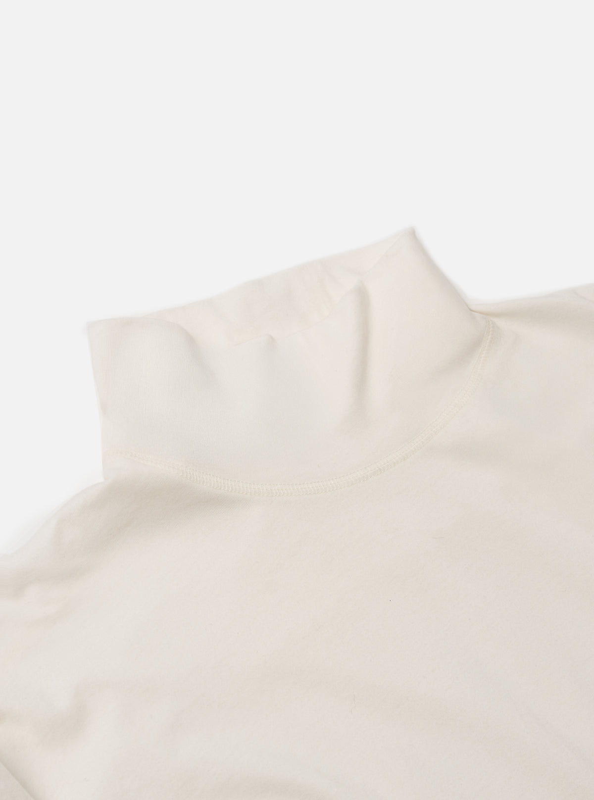 Close-up of the ecru Single Jersey Funnel Neck Tee on a white background. The soft, neutral-colored fabric is highlighted, showing the texture and the funnel neck design.