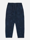The Black/Indigo Denim Camo Braga Pant laid on a white surface. The pants are a relaxed fit with a drawstring waist and a subtle camo pattern.