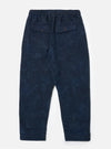 Back view of Black/Indigo Denim Camo Braga Pant on a white background. The pants have an elastic waist and two back pockets with button closures.