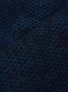 Close-up of the Black/Indigo Denim Camo Braga Pant fabric. The material has a subtle camo pattern in black and indigo. The fabric is textured and folded.