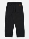 Back view of Black Works Twill Duke Pant on a white background. The black twill pants have a relaxed fit and feature a brown leather patch on the back pocket.