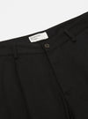 Close-up of the Black Works Twill Duke Pant. The black twill fabric is visible, along with the waistband, button, and belt loops. Shot on a white background.