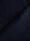 Close-up of the Navy Velveteen Oxford Pant fabric. The rich, dark navy velveteen material is folded, showcasing its soft texture and luxurious sheen.