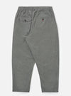 Back view of Charcoal Organic Chambray Oxford Pant on a white background. The pants are a relaxed fit with an elastic waistband and buttoned back pockets.