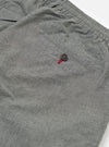 Close-up of the Charcoal Organic Chambray Oxford Pant on a white background, showing the elastic waist, buttoned back pocket, and chambray texture.
