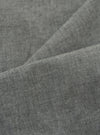 Close-up of the Charcoal Organic Chambray Oxford Pant fabric. The soft, textured material is draped to show its quality. The charcoal color is consistent throughout.