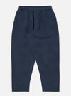 Dark navy patchwork weave cotton pleated track pant on a white background. The pants have a relaxed fit and a subtle textured pattern.