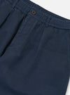 Close-up of the Dark Navy Patchwork Weave Cotton Pleated Track Pant on a white background. The cotton has a subtle patchwork weave texture.