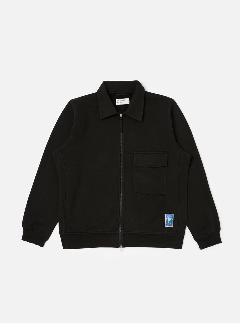 The Black Brush Back Sweat Tyler Sweat Jacket on a white background. The jacket is zipped up and has a pocket on the chest and a logo on the bottom.