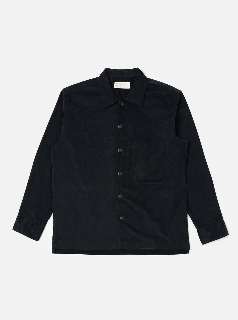 The Black Organic Fine Cord Fatigue Shirt is laid flat on a white background. The shirt is a dark color and made of corduroy. It has long sleeves and a button-up front.
