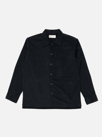 The Black Organic Fine Cord Fatigue Shirt is laid flat on a white background. The shirt is a dark color and made of corduroy. It has long sleeves and a button-up front.