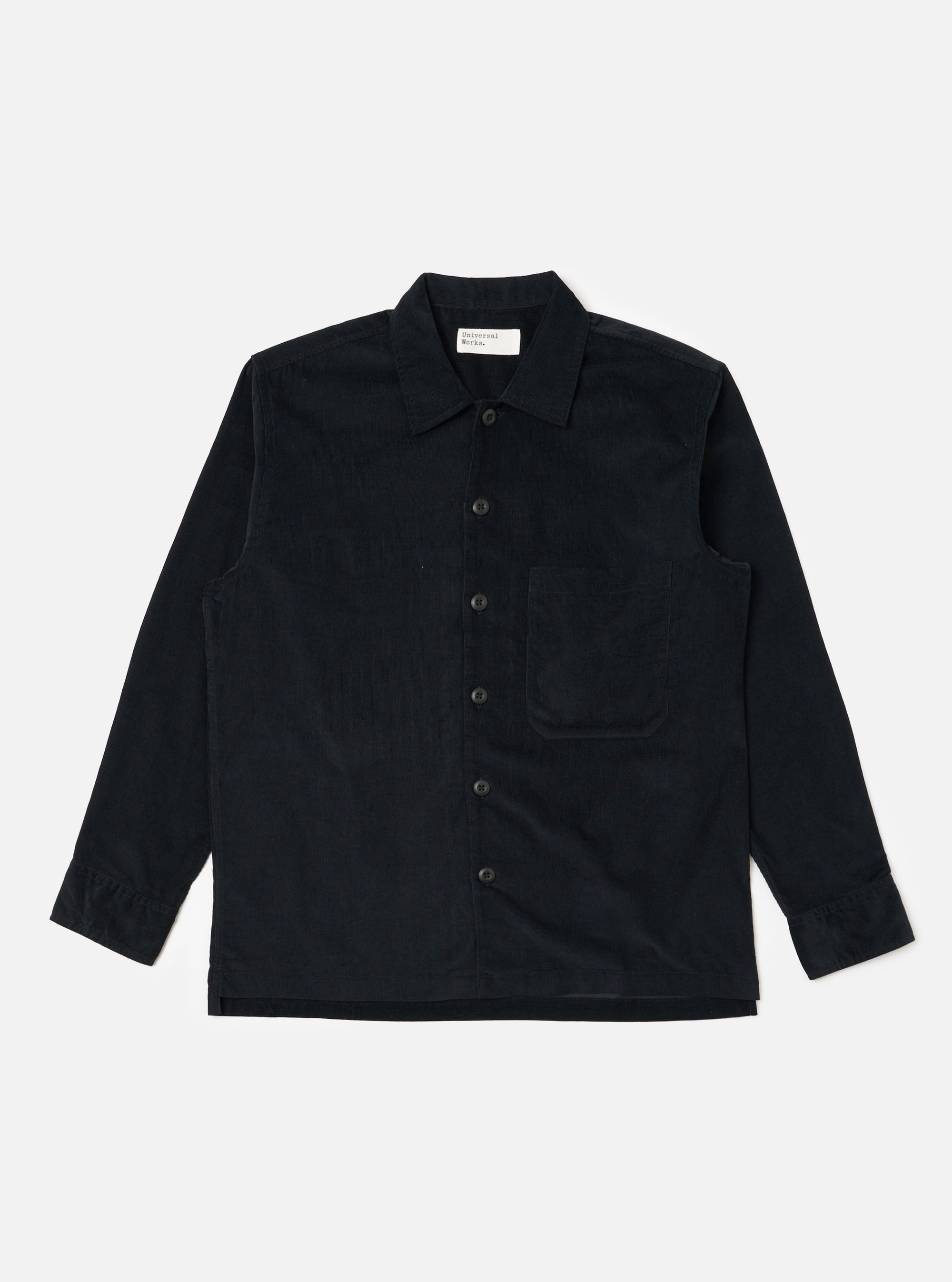 The Black Organic Fine Cord Fatigue Shirt is laid flat on a white background. The shirt is a dark color and made of corduroy. It has long sleeves and a button-up front.