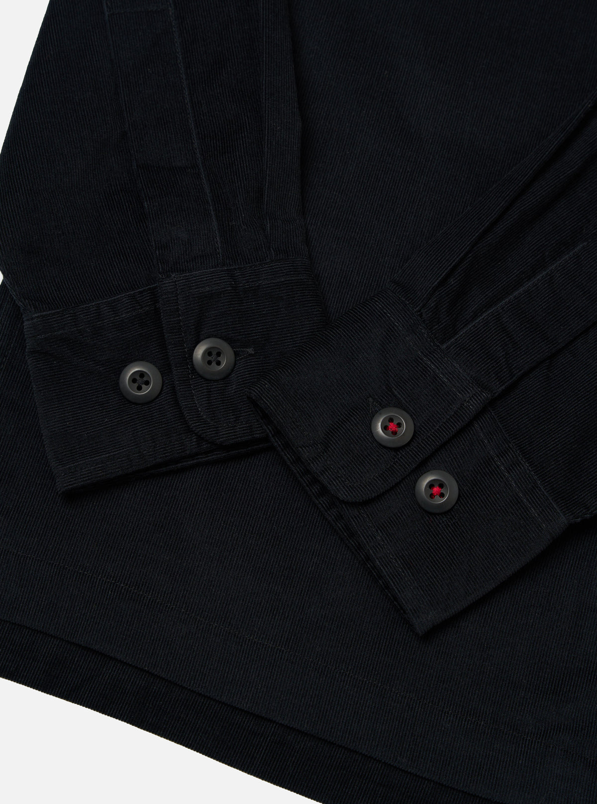 Close-up of the Black Organic Fine Cord Fatigue Shirt showing the fine cord material, button details, and the shirt's texture against a plain background.