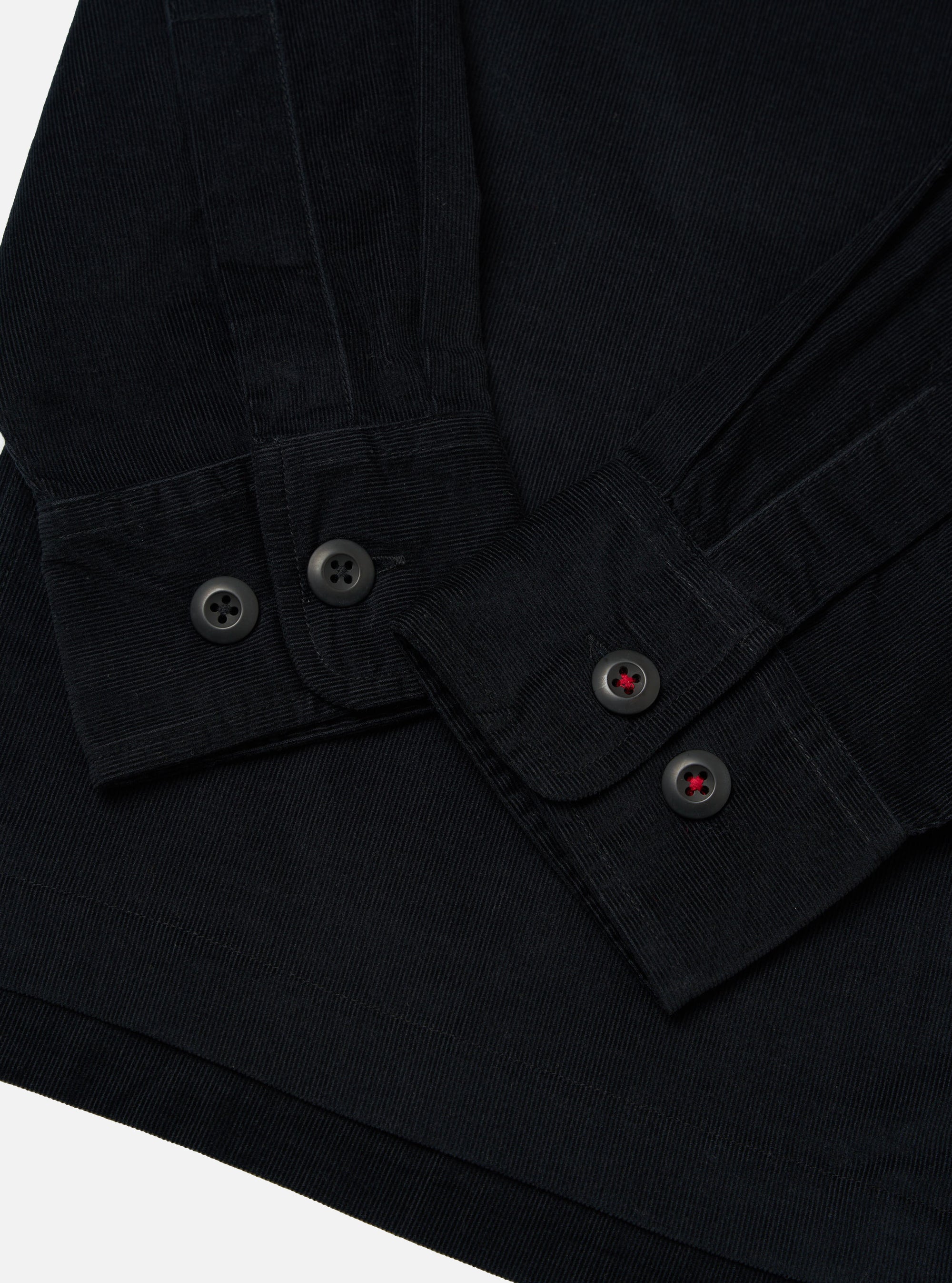 Close-up of the Black Organic Fine Cord Fatigue Shirt showing the fine cord material, button details, and the shirt's texture against a plain background.