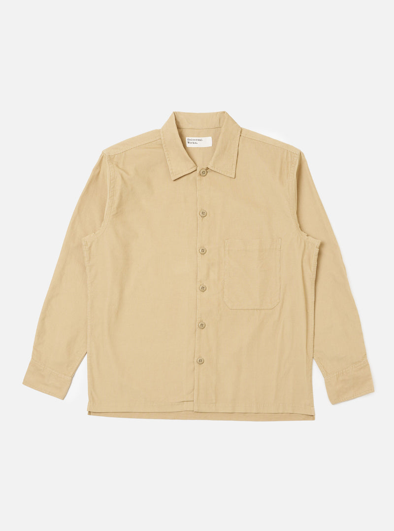 The Sand Organic Fine Cord Fatigue Shirt, laid flat on a white background. The shirt is a light tan color and made of fine corduroy. It has long sleeves, a button-down front, and a chest pocket.