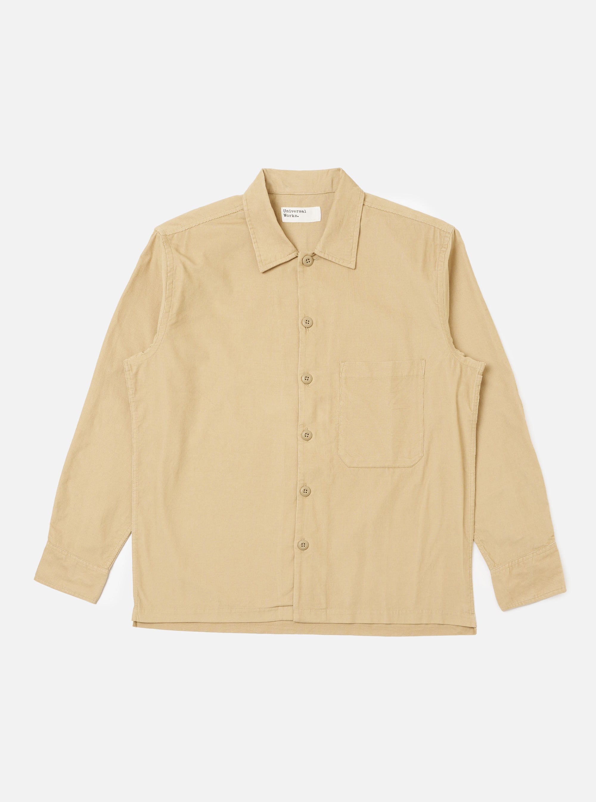 The Sand Organic Fine Cord Fatigue Shirt, laid flat on a white background. The shirt is a light tan color and made of fine corduroy. It has long sleeves, a button-down front, and a chest pocket.