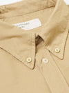 Close-up of the Sand Organic Fine Cord Daybrook Shirt, showing the fine corduroy texture, button-down collar, and light-colored buttons. The shirt is laid flat on a white surface.