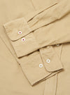 Close-up of the sand-colored Organic Fine Cord Daybrook Shirt, showcasing the fine corduroy texture and button details. The shirt is neatly folded on a neutral surface.