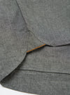 Close-up of the Charcoal Organic Chambray Patched Lazy Day Shirt showing the fabric texture and stitching details. The shirt is laid flat on a white surface.