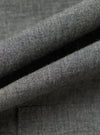 Close-up of the Charcoal Organic Chambray Patched Lazy Day Shirt fabric. The charcoal chambray material is folded to show texture and detail. 