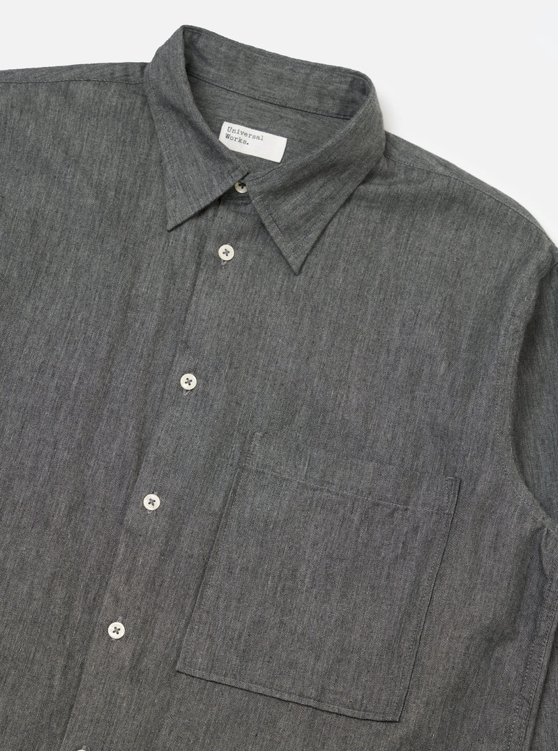 Close-up of the Charcoal Brushed Organic Cotton Square Pocket Shirt on a white background. The shirt is buttoned with a square pocket.