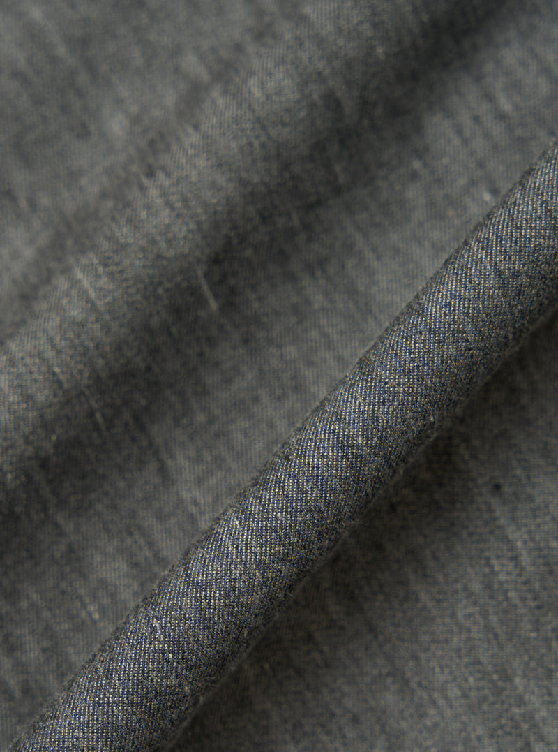 Close-up of the Charcoal Brushed Organic Cotton Square Pocket Shirt fabric. The charcoal material is folded to show texture.