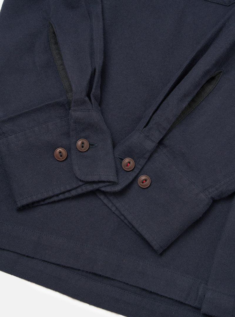 Close-up of the Dark Navy Sid Flannel CPO Shirt on a white surface. Shows the flannel texture, button details, and sleeve construction.