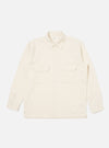 The Ecru Sid Flannel CPO Shirt in a light cream color, laid flat on a white background. The shirt has a relaxed fit, two chest pockets, and button-down closure.