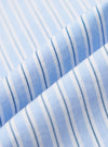 Close-up of the Blue Office Stripe Square Pocket Shirt fabric. Light blue and white stripes with a subtle texture. The fabric is folded, creating depth.