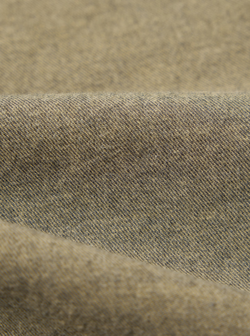 Close-up of the Mustard Brushed Marl Twill Square Pocket Shirt fabric. The twill weave is visible in shades of mustard and dark gray.