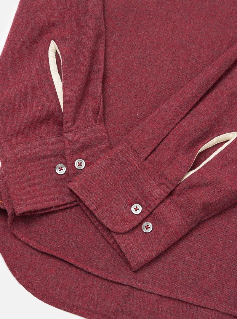 Close-up of the Red Brushed Marl Twill Square Pocket Shirt on a white surface. Shows the texture of the red marl twill, the buttoned cuffs, and the square pocket detail.
