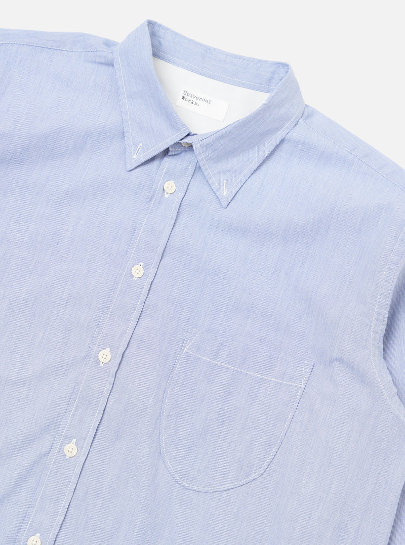Close-up of the Blue Classic Stripe Lazy Day Shirt on a white background. The shirt is light blue with thin white stripes and has a pocket.