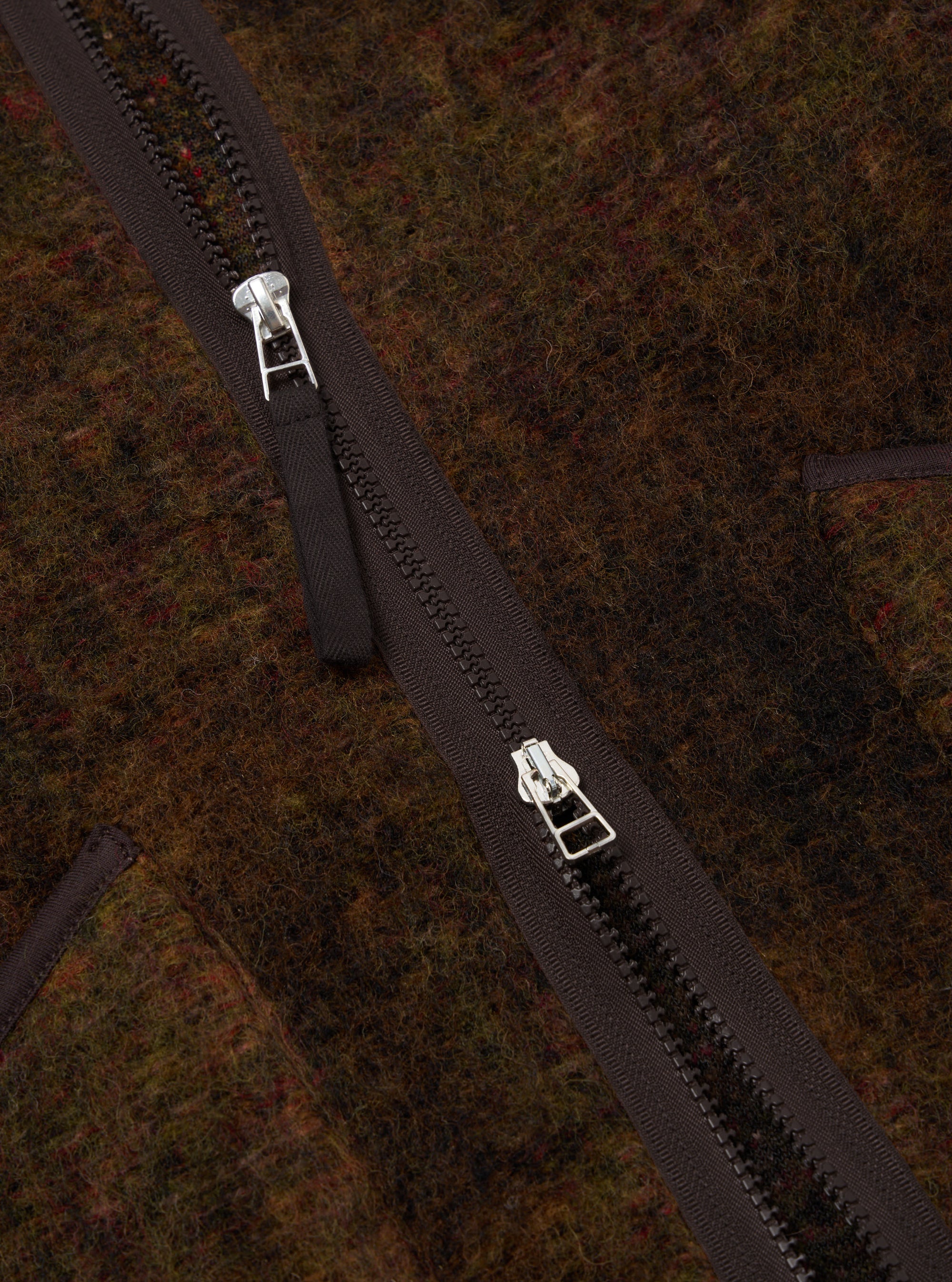 Close-up of the Brown Alps Fleece Zip Liner Jacket showing the texture of the fleece and the zipper detail. The jacket is brown with a dark brown zipper.