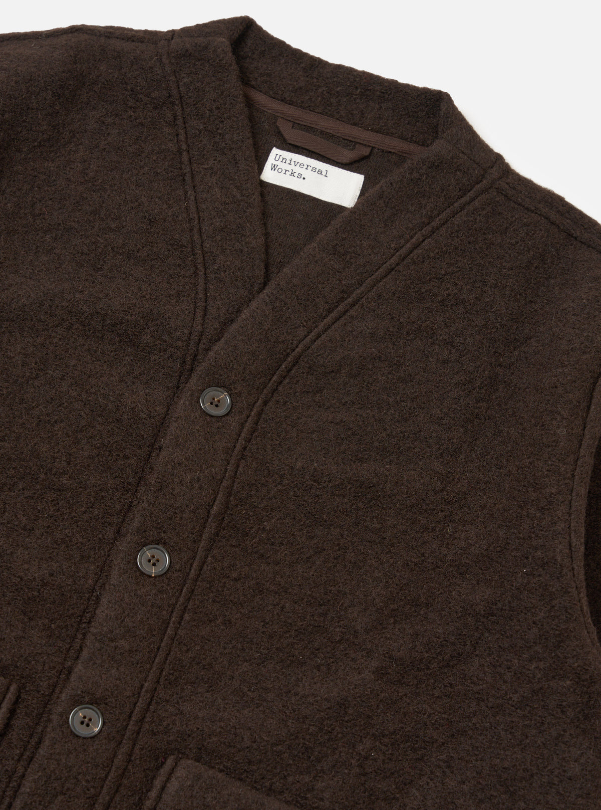 Close-up of the Brown Wool Fleece Advance Cardigan on a white background. The cardigan is brown, made of wool fleece, and has a button-up closure.