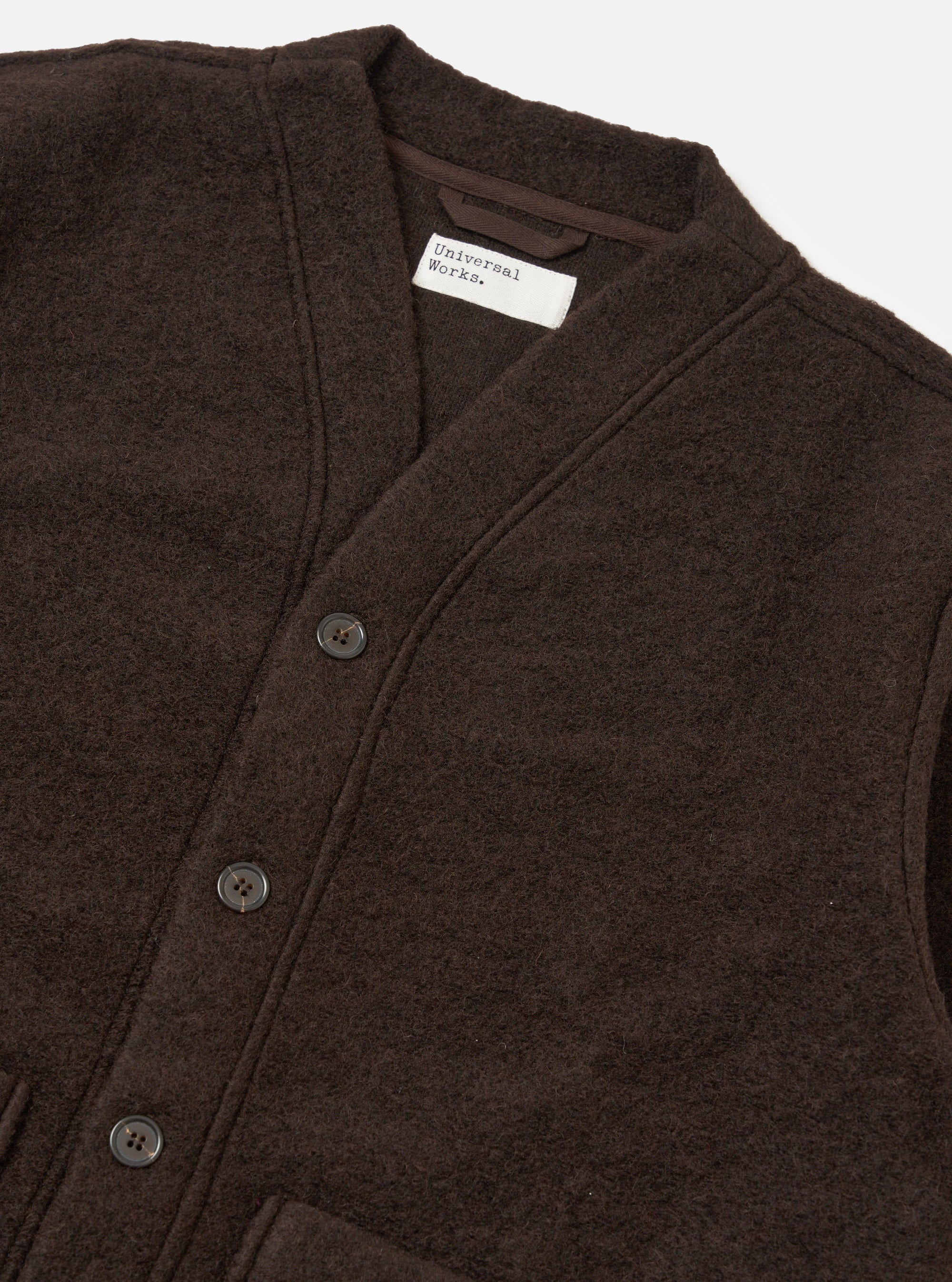 Close-up of the Brown Wool Fleece Advance Cardigan on a white background. The cardigan is brown, made of wool fleece, and has a button-up closure.