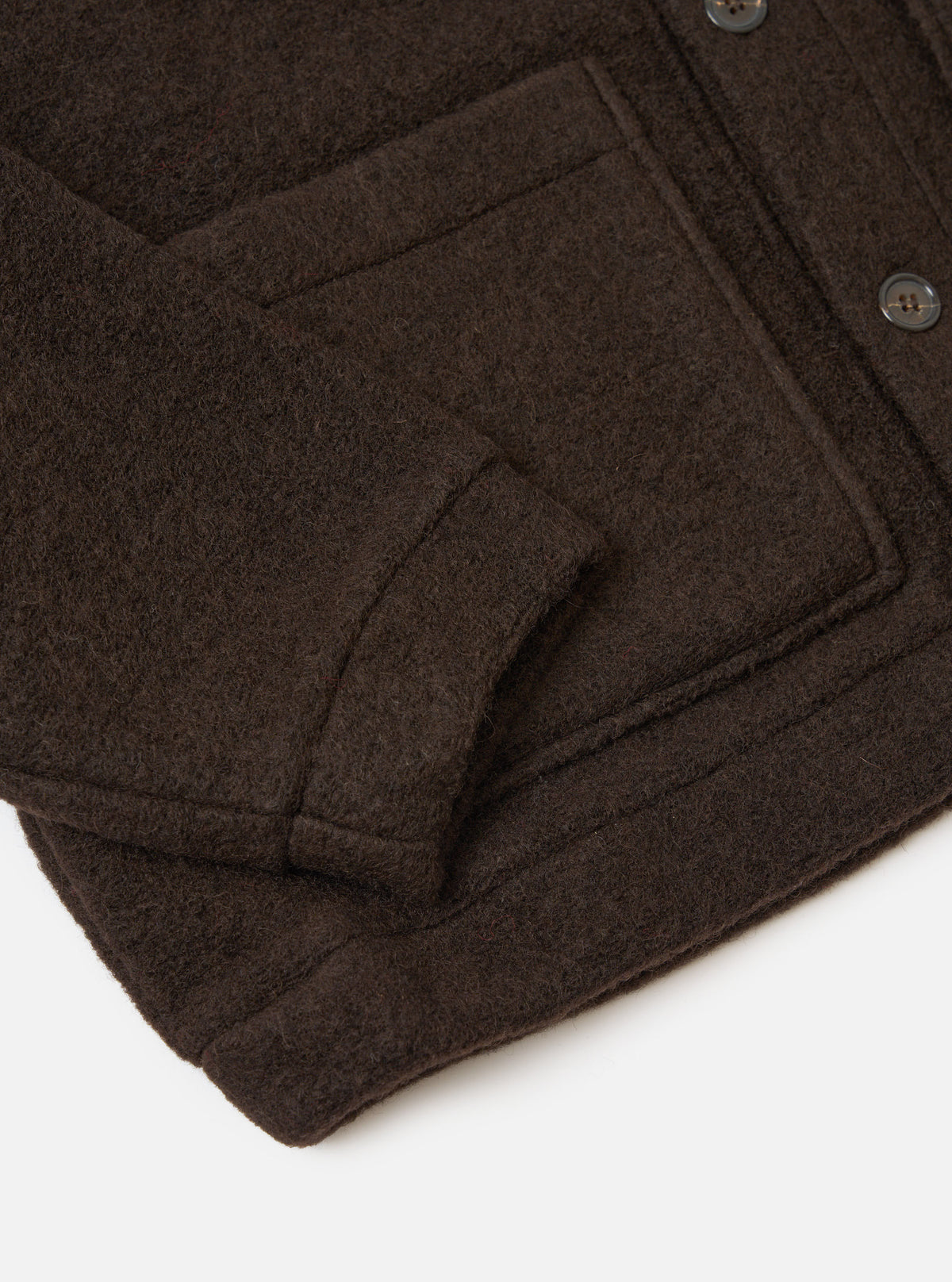 Close-up of the Brown Wool Fleece Advance Cardigan on a white background, showing the texture and details of the wool fleece material and button.