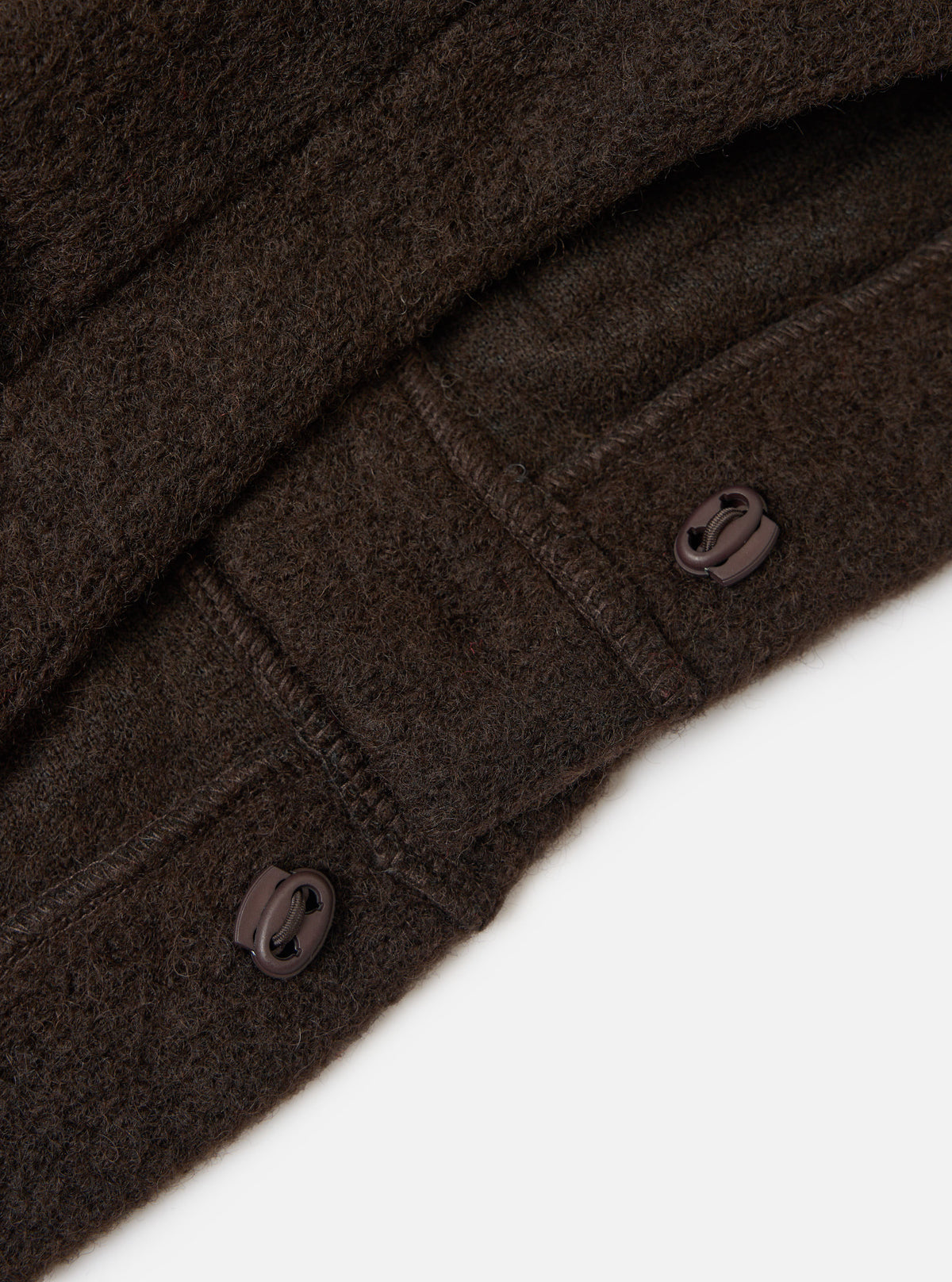 Close-up of the Brown Wool Fleece Advance Cardigan on a white background, showing the texture of the wool and the toggle buttons.