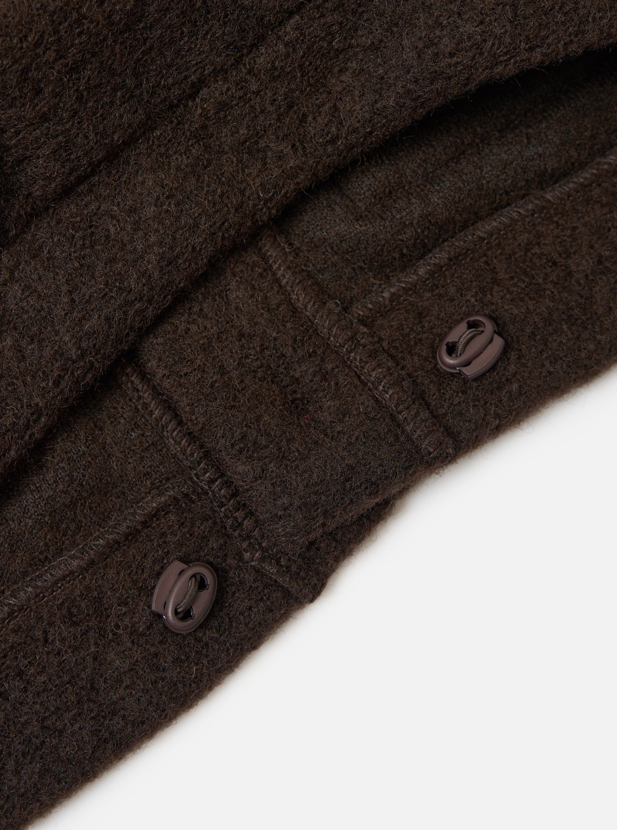 Close-up of the Brown Wool Fleece Advance Cardigan on a white background, showing the texture of the wool and the toggle buttons.