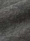 Close-up of the Grey Marl Wool Fleece Advance Cardigan fabric. The soft, textured wool is shown in detail, highlighting its grey marl color and fleece-like texture.