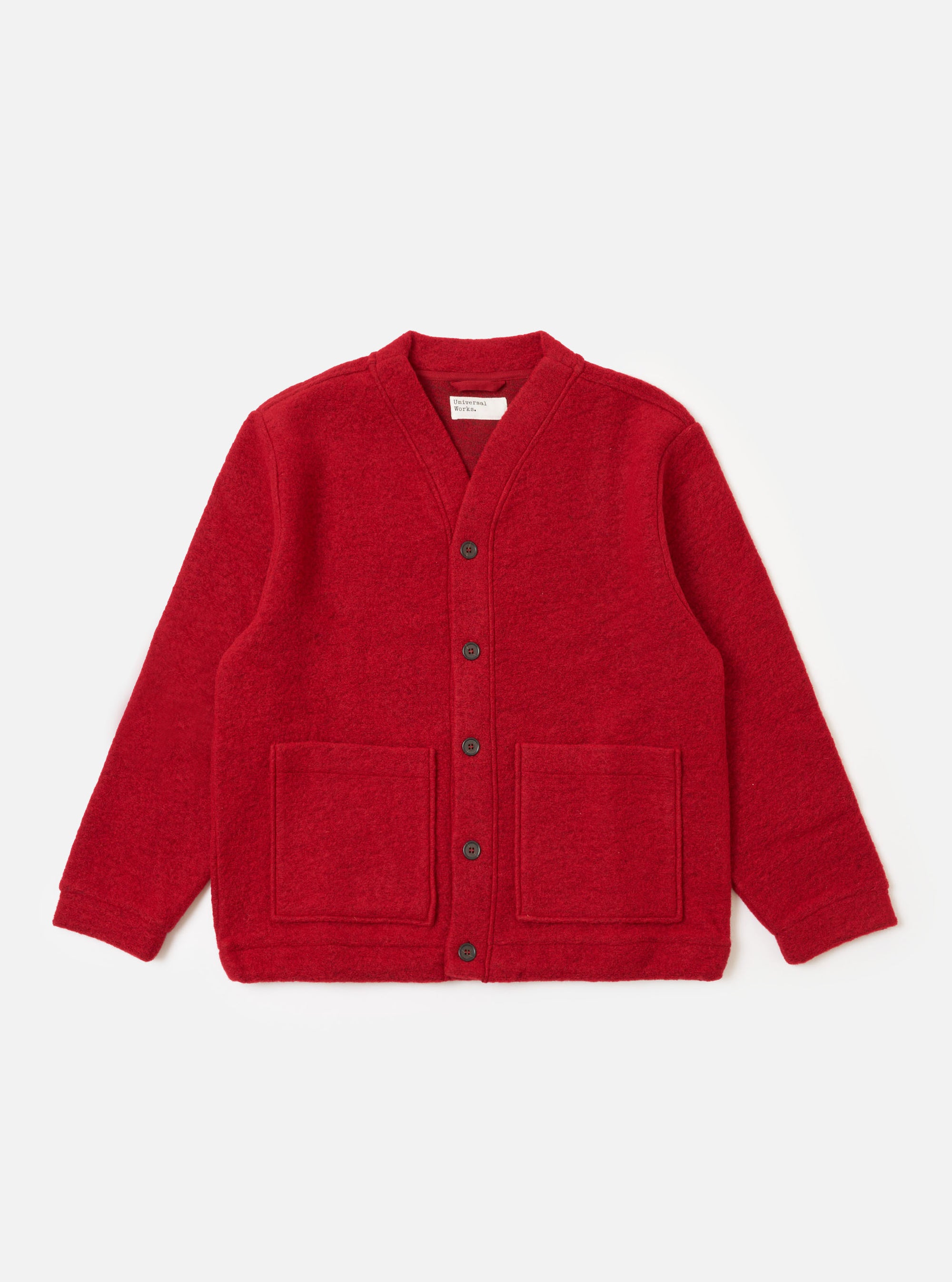 The Red Wool Fleece Advance Cardigan, in red fleece, is laid flat on a white background. It features a button-up front and two square pockets.