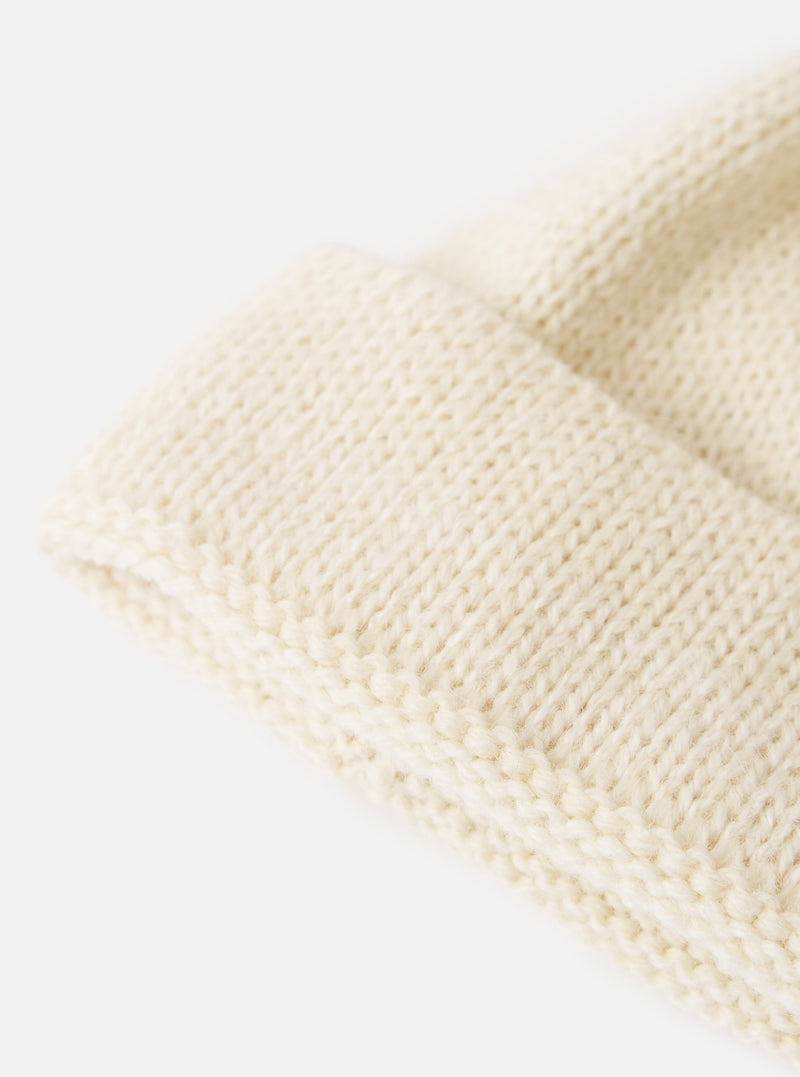 Close-up of the Ecru Alpaca/British Wool Bobble Hat showing the knit detail. The hat is on a white background.