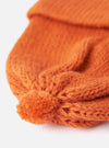 Close-up of an Orange Alpaca/British Wool Bobble Hat on a white background. The knit is chunky and textured, showing the quality of the wool.